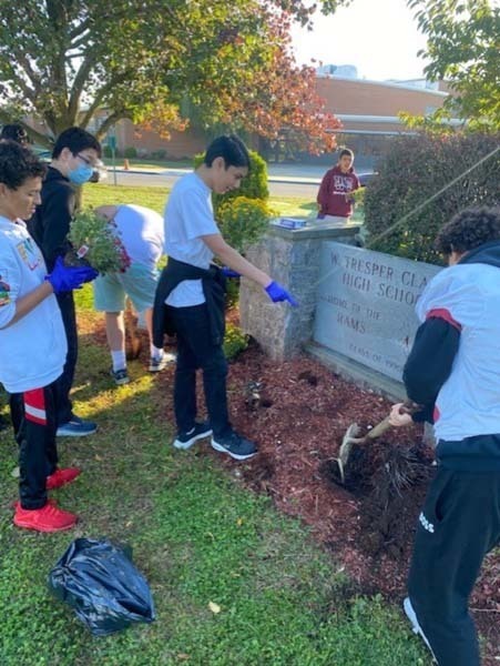 W.T. Clarke High School students plant vibrant, colorful flowers