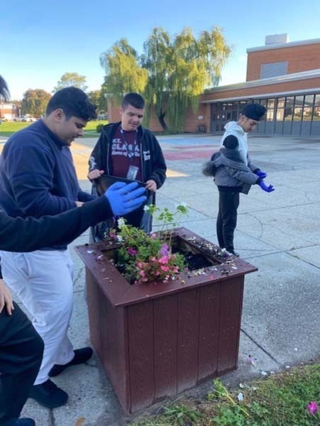 W.T. Clarke High School students plant vibrant, colorful flowers