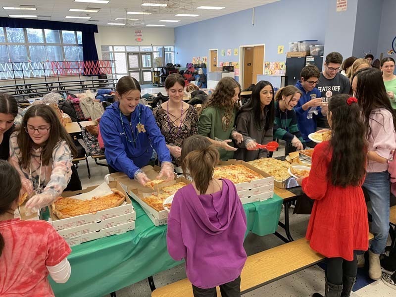 People getting food from a long table