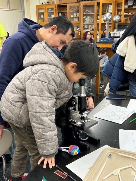 A student looking through a microscope