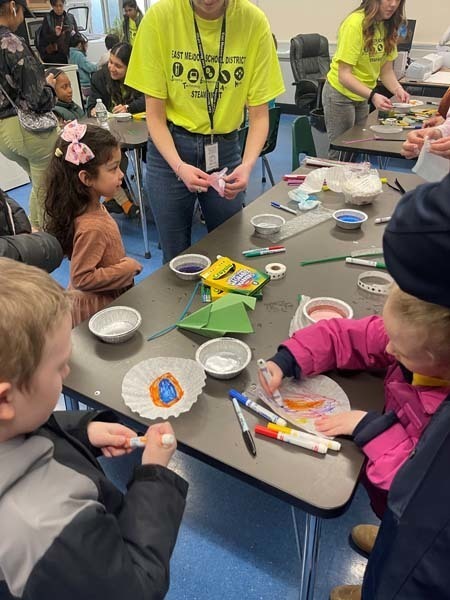 Students coloring at a table