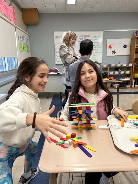 Students using stacking materials at a table