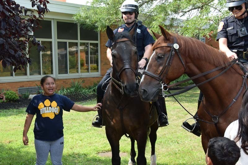 From armored vehicles to police horses, the Nassau County Police Department held a fun, interactive presentation for students in the East Meadow School District’s Extended School Year program on Aug. 3.   Members of the NCPD lined up trucks, motorcycles and cars near Bowling Green Elementary School’s main entrance as students learned about police officers and their day-to-day duties. In addition to touring the police cars and armored vehicles, students also got a hands-on experience about some of the NCPD’s equipment. Additionally, they shared thank-you cards with the police department to show gratitude for their local officers.   The district thanks the Nassau County Police Department for taking time to educate the students on their daily tasks and responsibilities. 